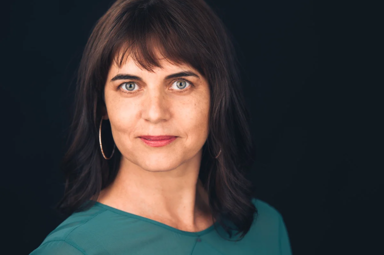 A woman with dark hair posing for a photo
