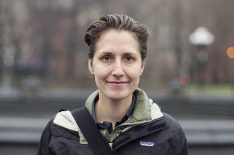 A person wearing a jacket posing for a photo